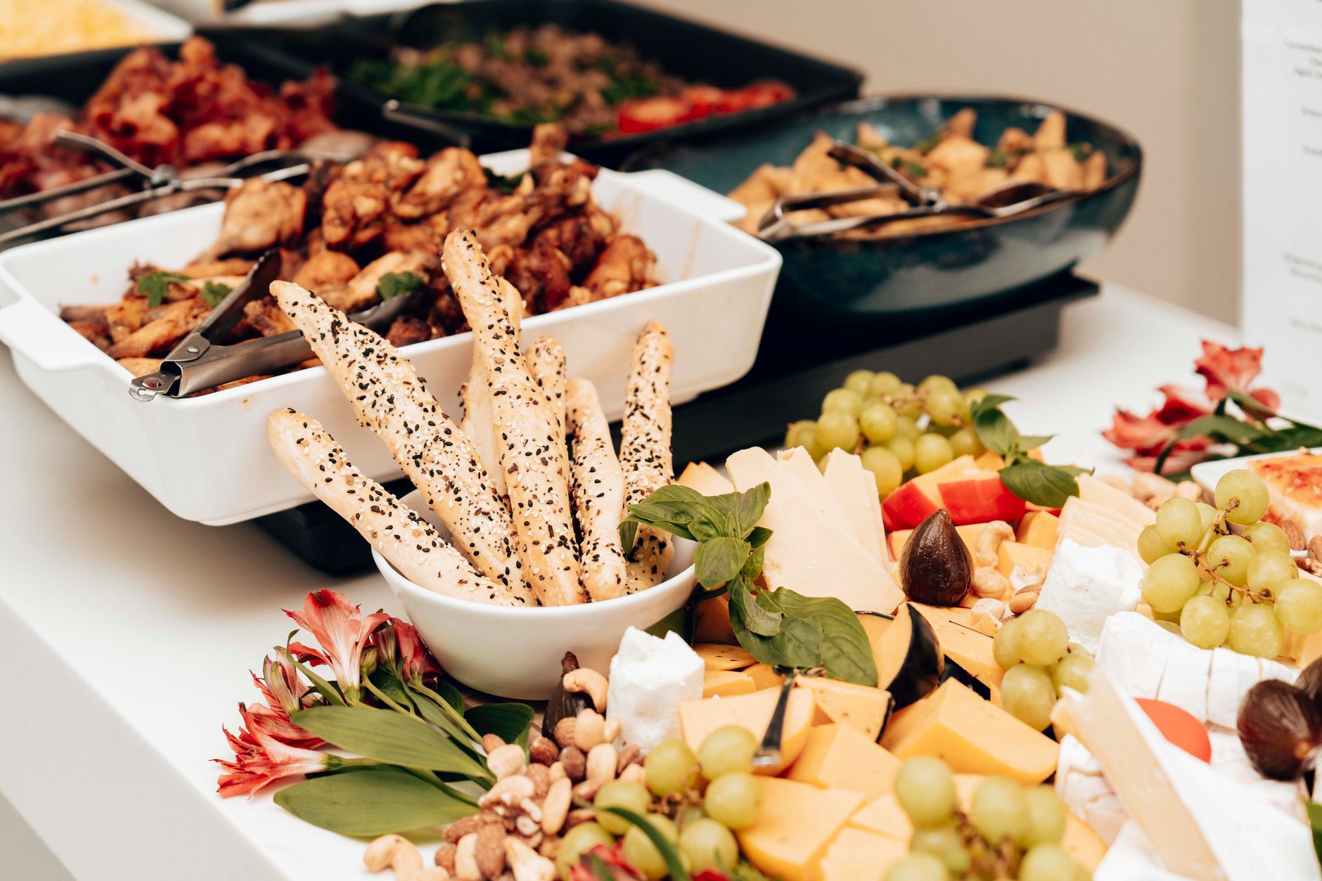 A catering spread of barbecue trays